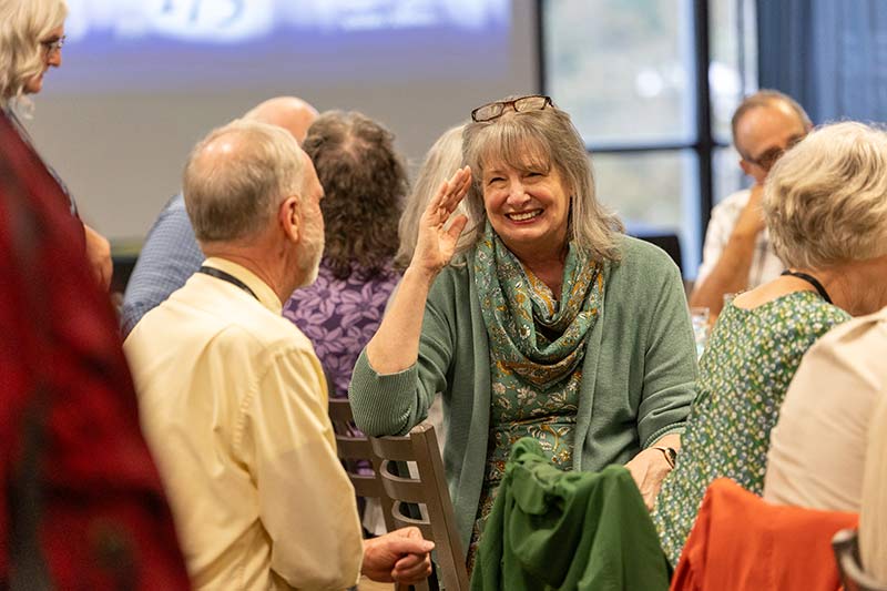 Woman smiling at a Geneva College Alumni event